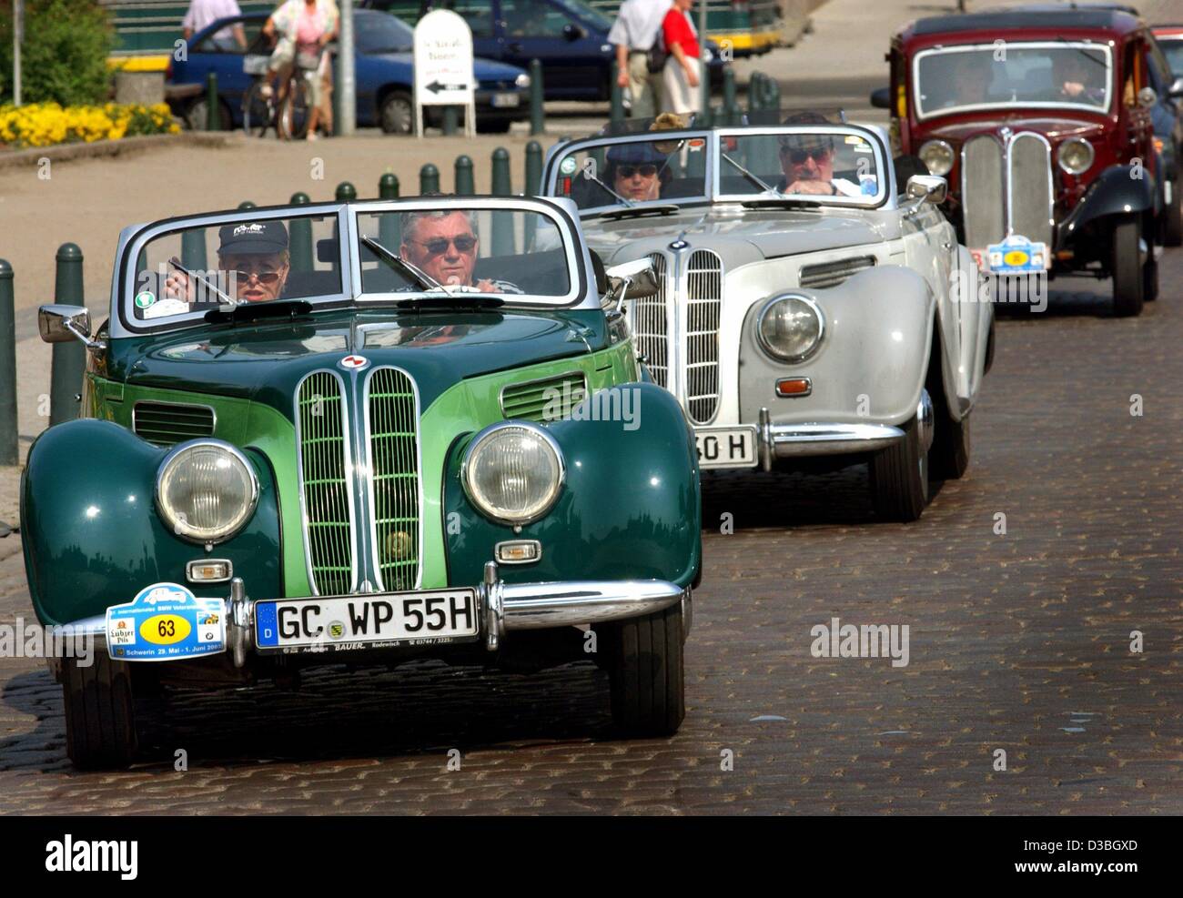 (dpa) - The Pfau family drive their BMW 327 from the year 1954 during a parade at the 27th international veteran BMW meeting in Schwerin, Germany, 31 May 2003. About 150 historic BMW cars and motorbikes take part in the four-day meeting. Stock Photo