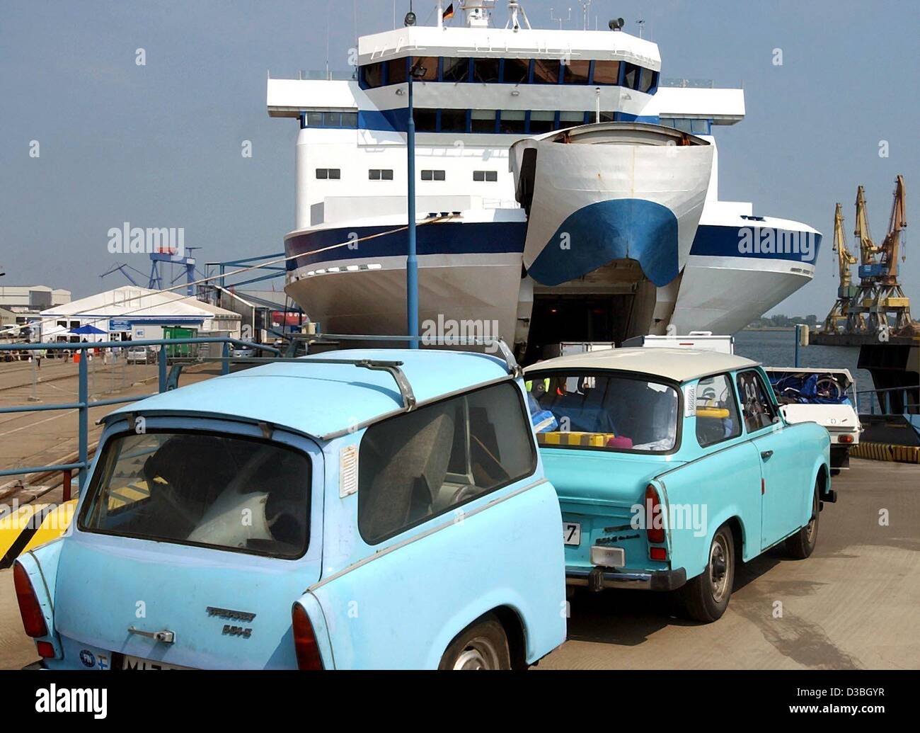 (dpa) - A turquoise Trabant (Trabi) car with a blue 'Trabi-trailer' queues for the gas turbine ship Finnjet of Silja Line in the harbour in Rostock, Germany, 4 June 2003. With 30 knots (about 56 kmph) the ship is the fastest ferry on the Baltic Sea. It is already in its fifth season to make the trip Stock Photo