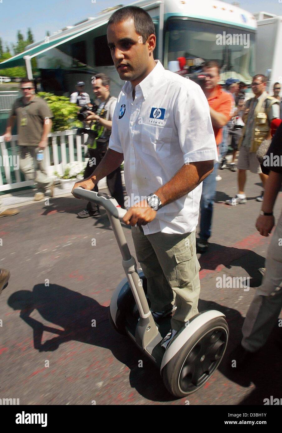 (dpa) - Colombian formula one pilot Juan Pablo Montoya speeds around the paddock on a Segway scooter on the Circuit Gilles Villeneuve race track in Montreal, Canada, 12 June 2003. The Great Prize of Canada will take place on 15 June. Stock Photo