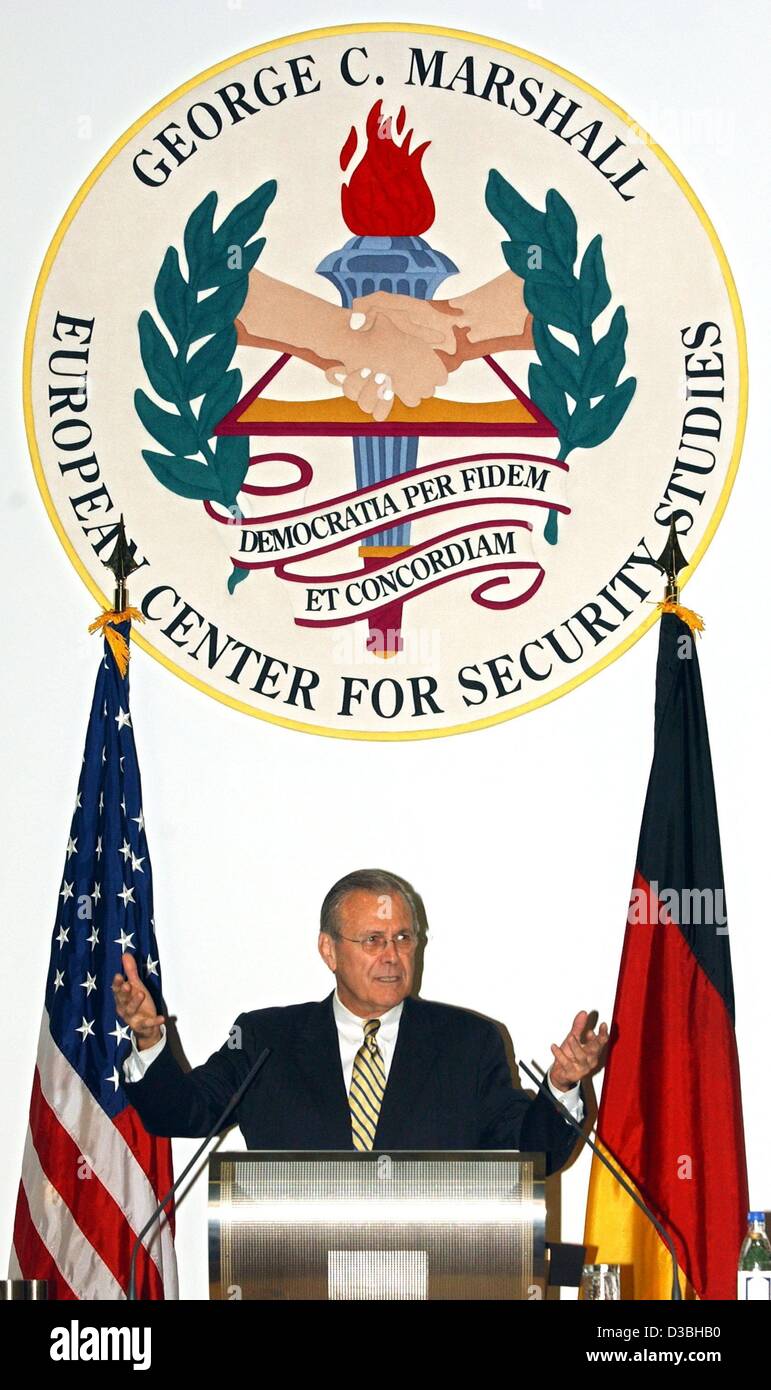 (dpa) - US Defence Minister Donald Rumsfeld is gesturing between the flags of Germany and the USA and the logo of the Marshall Center, Garmisch-Partenkirchen, Germany, 11 June 2003. Rumsfeld has come for the 10th anniversary of the 'George C. Marshall European Center for Security Studies'. Rumsfeld  Stock Photo