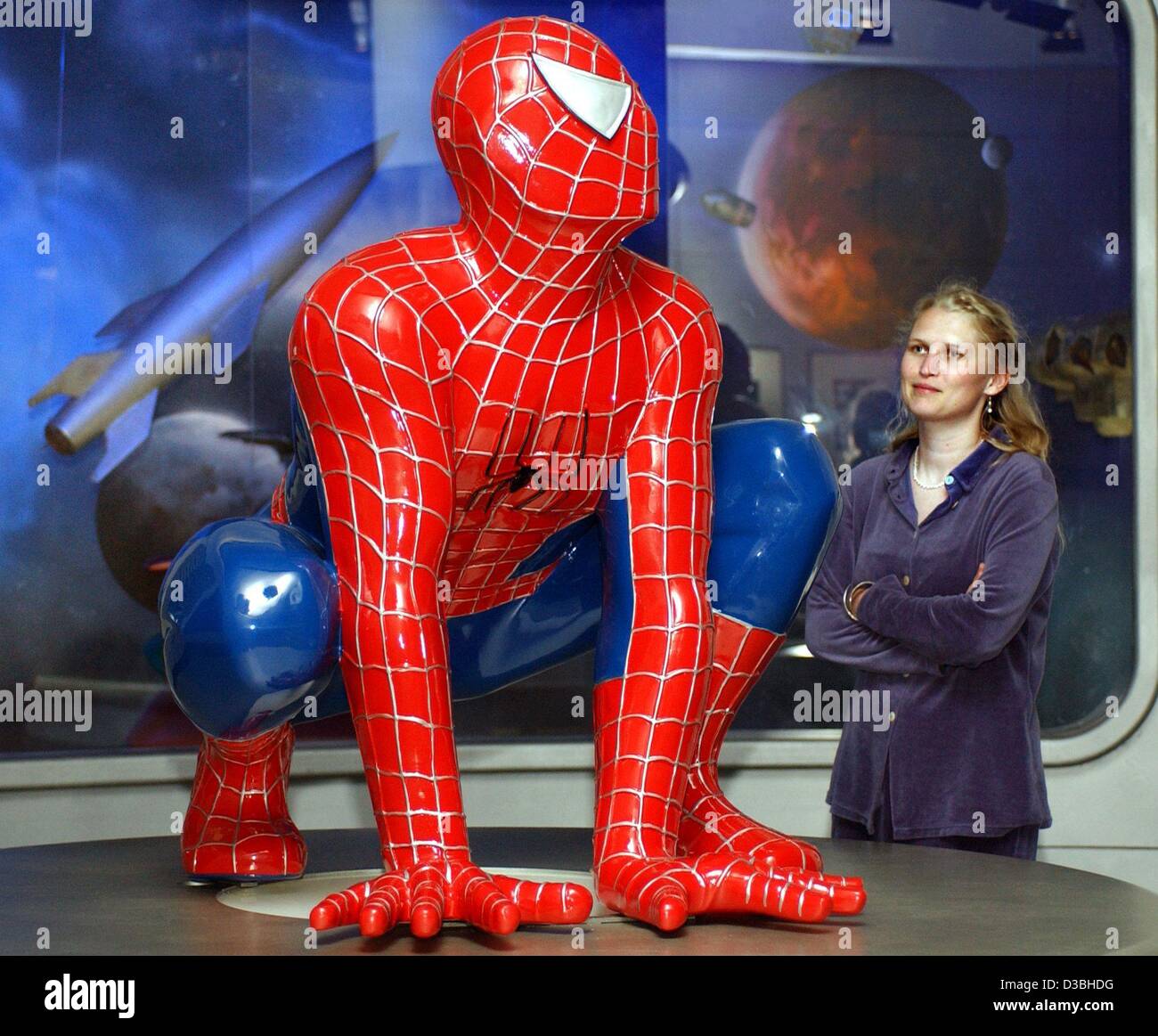 Dpa A Woman Looks At A Spider Man Figure Squatting On The Floor
