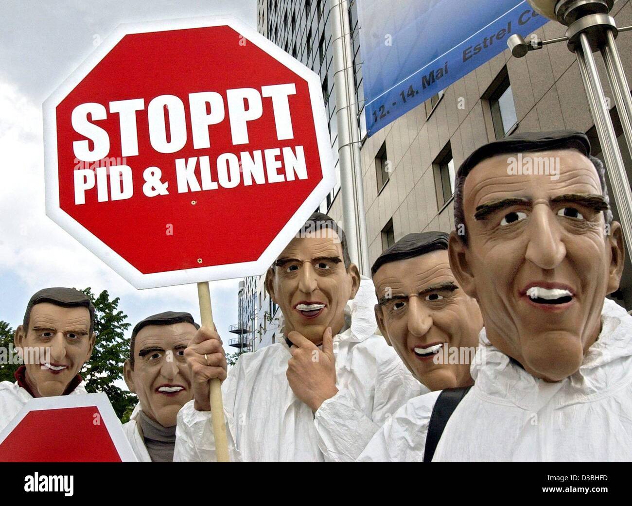 (dpa) - Portesters wear masks resembling German Chancellor Gerhard Schroeder and carry symbolic stop signs which read 'Stop PID and Cloning' in protest of a conference on cloning in Berlin, 14 May 2003. The protesters rallied against the cloning of humans and the artificial selection through preimpl Stock Photo