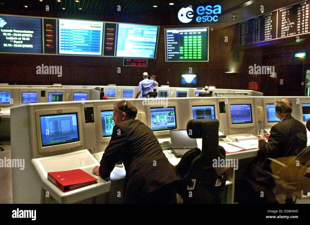 (dpa) - Scientists sit in front of monitors and follow the launch phase of the European planetary space probe 'Mars Express' at the mission control centre (ESOC) of the European Space Agency (ESA) in Darmstadt, Germany, 2 June 2003. The probe was launched from the Russian spaceport in Baikonur and i Stock Photo