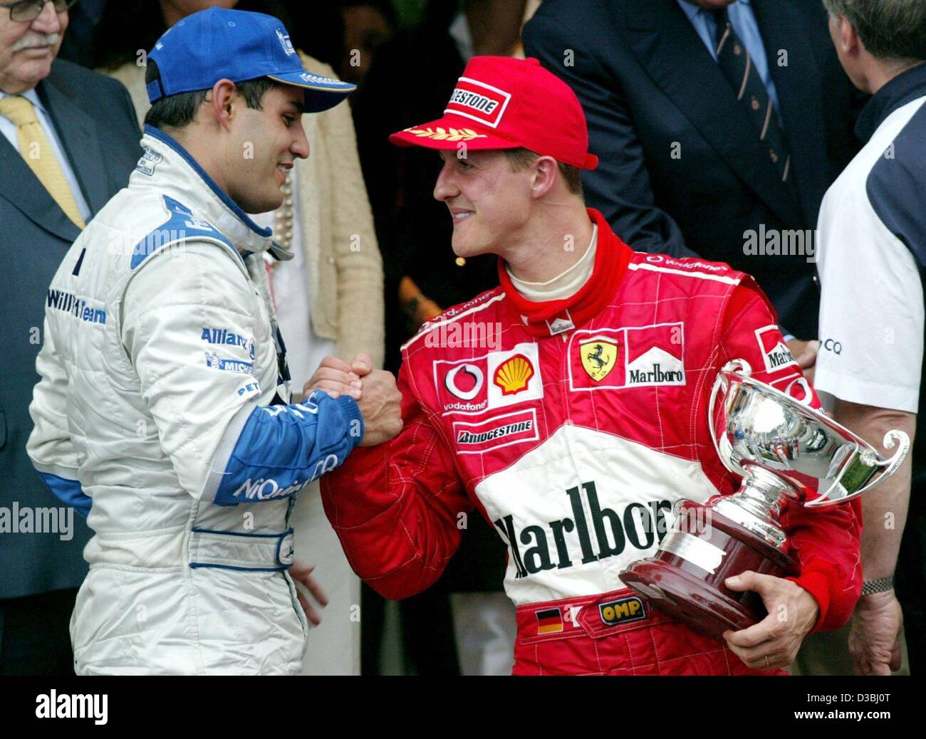(dpa) - Colombian formula one pilot Juan Pablo Montoya (L) congratulates third-placed Michael Schumacher (R, Ferrari) after the Grand Prix of Monaco in Monte Carlo, 1 June 2003. Montoya finishes first and celebrates the first victory of BMW Williams this season. Stock Photo