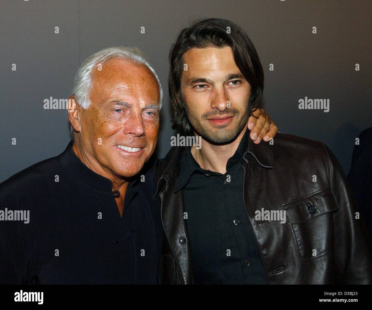 (dpa) - French actor Olivier Martinez (R) and Italian fashion designer Giorgio Armani pose during Armani's party for the opening of his exhibition in Berlin, 7 May 2003. The exhibition shows 500 Armani creations of the last 30 years. Some of the exhibits are pieces made for movie stars. 68-year-old  Stock Photo