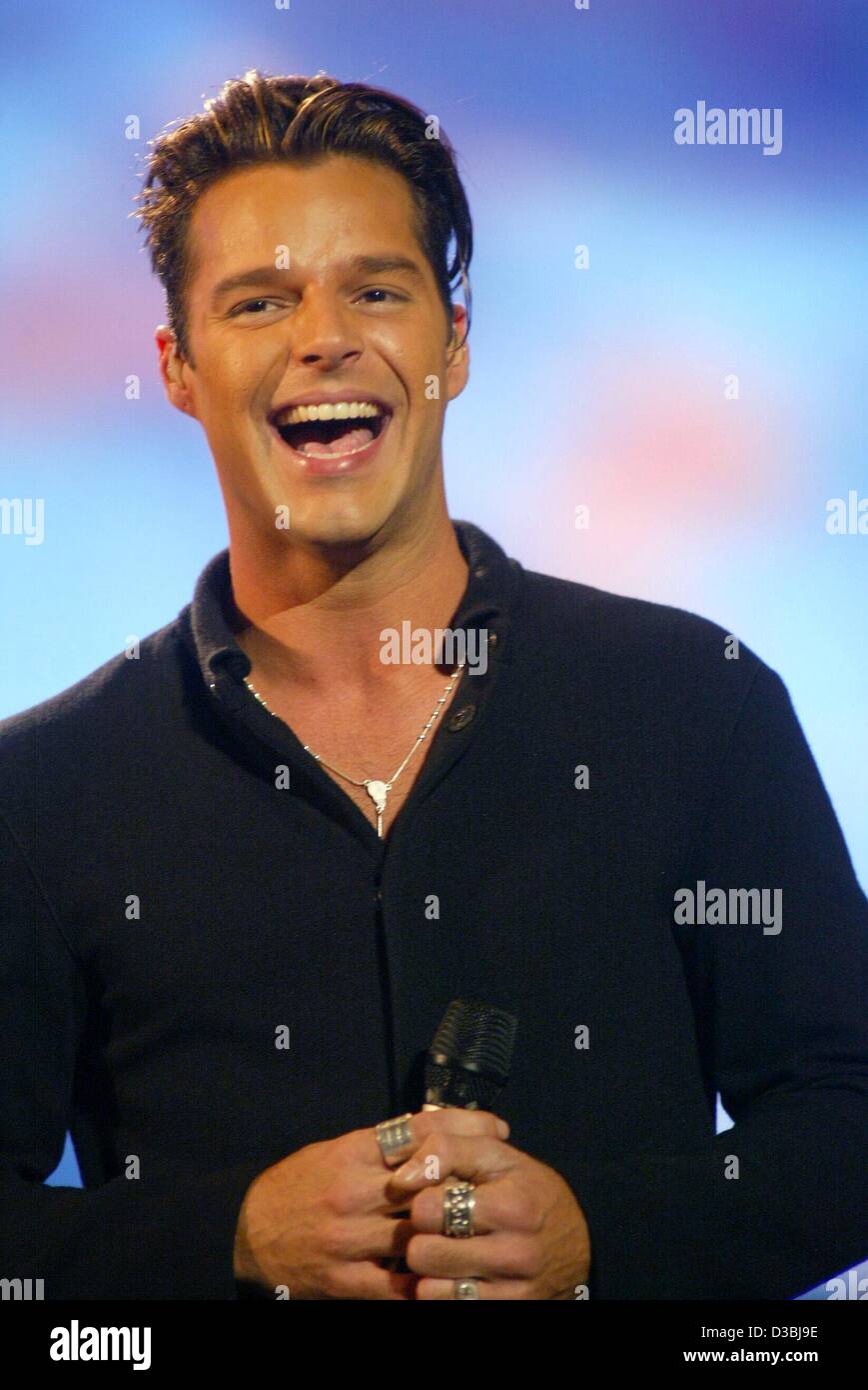 (dpa) - Puertorican pop singer Ricky Martin smiles during his performance at the '10th Pavarotti and Friends' charity concert in Modena,Italy, 27 May 2003. Stock Photo