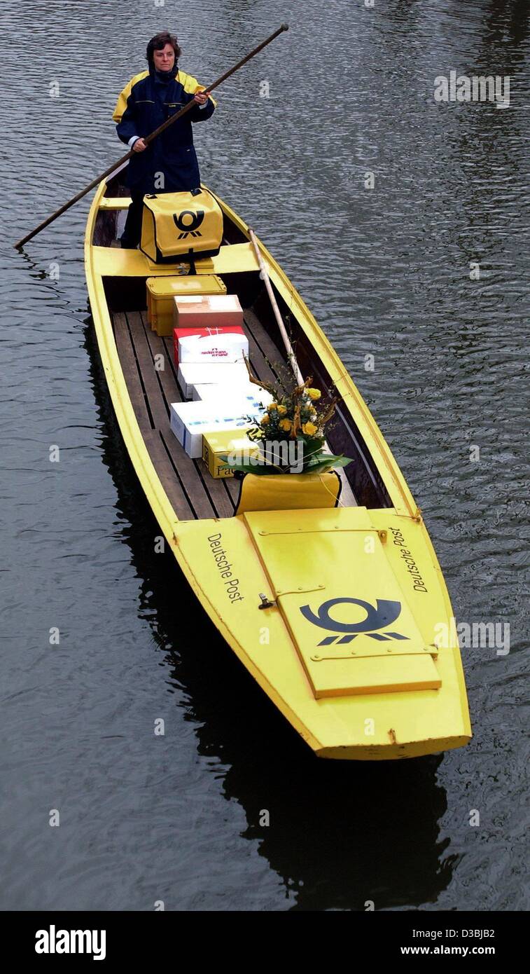 (dpa) - Postwoman Jutta Pudenz maneuvres her yellow post punt along a river in Luebbenau, Germany, 5 April 2003. She is the only postwoman nationwide to deliver the mail with a punt. Stock Photo