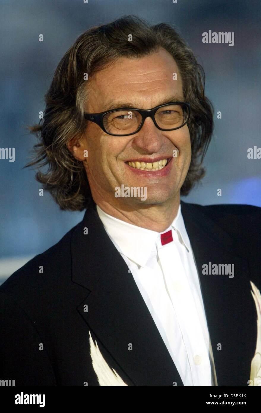 (dpa) - German film director Wim Wenders is all smiles during the closing ceremony of the 56th Cannes film festival in Cannes, France, 25 May 2003. Wenders presented the Golden Camera award for the film 'Reconstruction'. Stock Photo