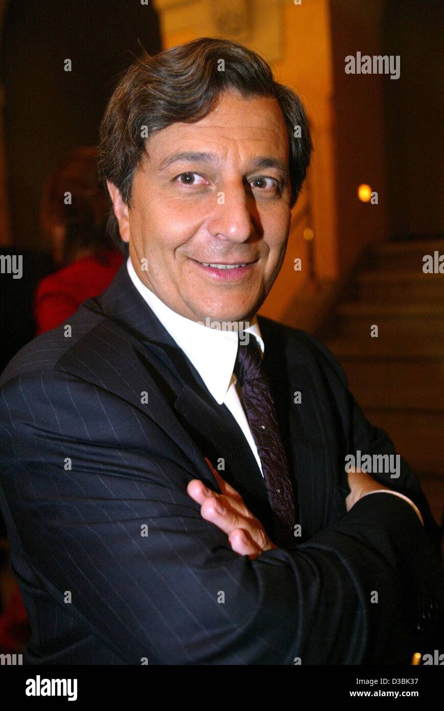 (dpa) - The French actor Christian Clavier ('Les visiteurs'/'The Visitors') smiles during the award ceremony of the Bayerischer Fernsehpreis (Bavarian TV prize) in Munich, 23 May 2003. The producer of the German-French mini series 'Napoleon', starring Clavier, won an award for the series. The prize  Stock Photo