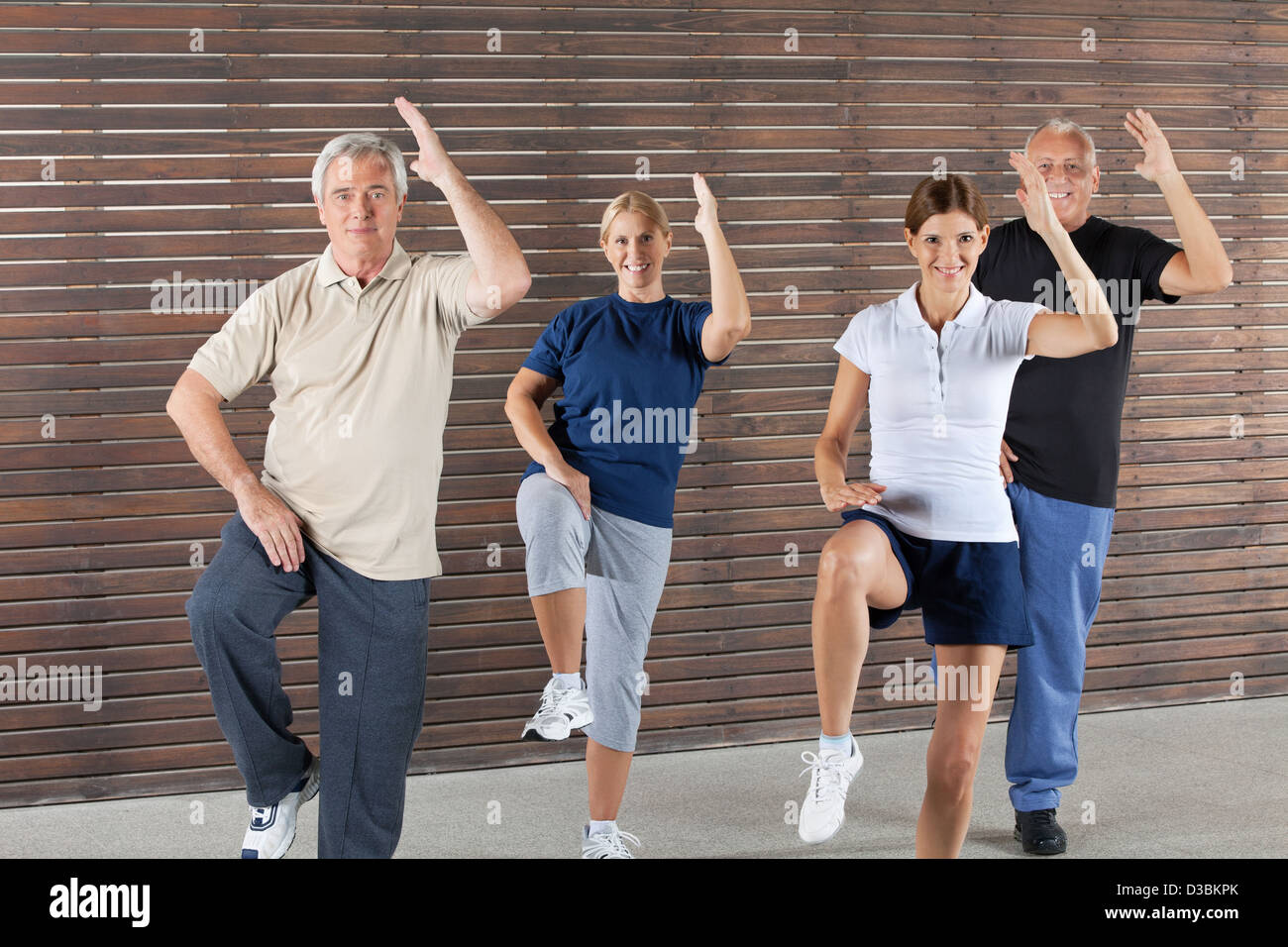 Happy seniors doing aerobic exercises in gym Stock Photo