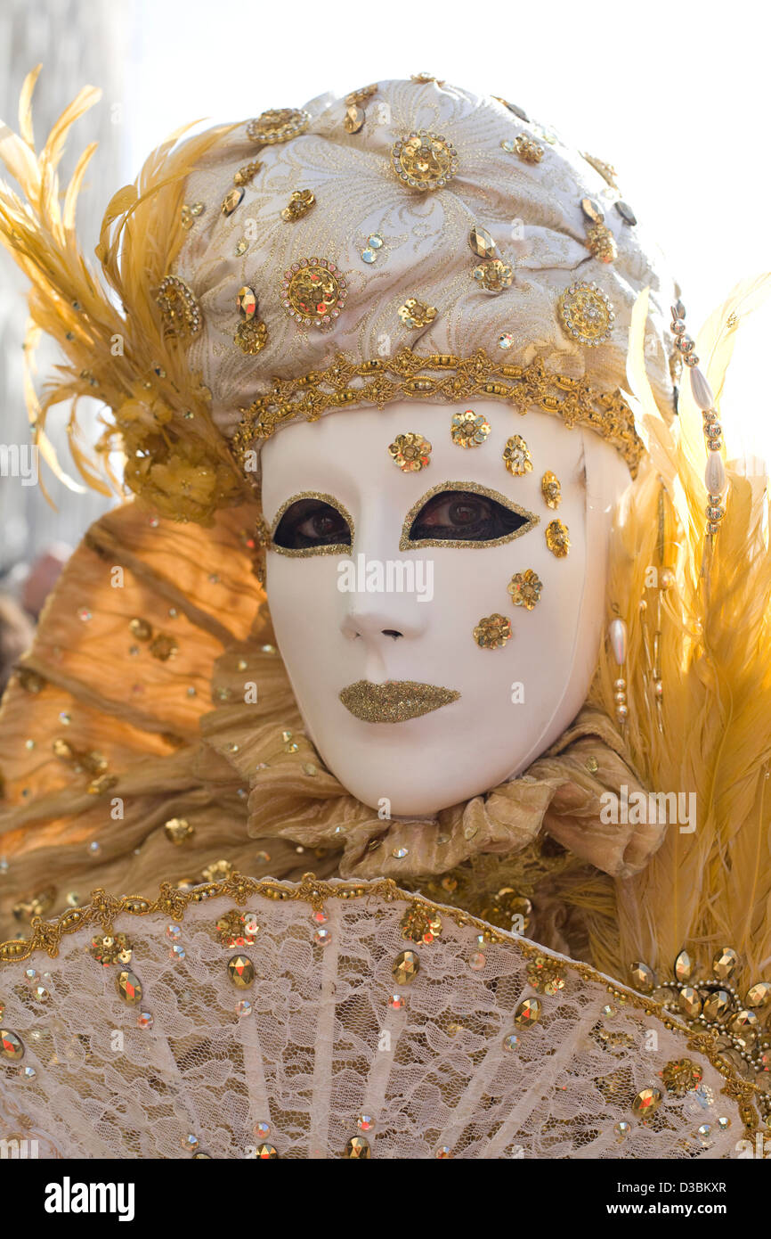 Traditional Venetian masks being worn at the carnival of Venice in San marco square Venice Stock Photo