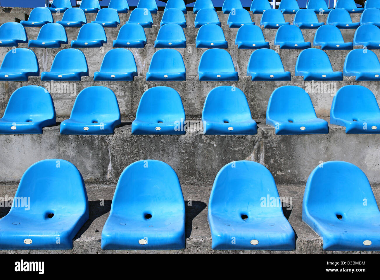 https://c8.alamy.com/comp/D3BMBM/blue-plastic-old-stadium-seats-on-concrete-steps-D3BMBM.jpg