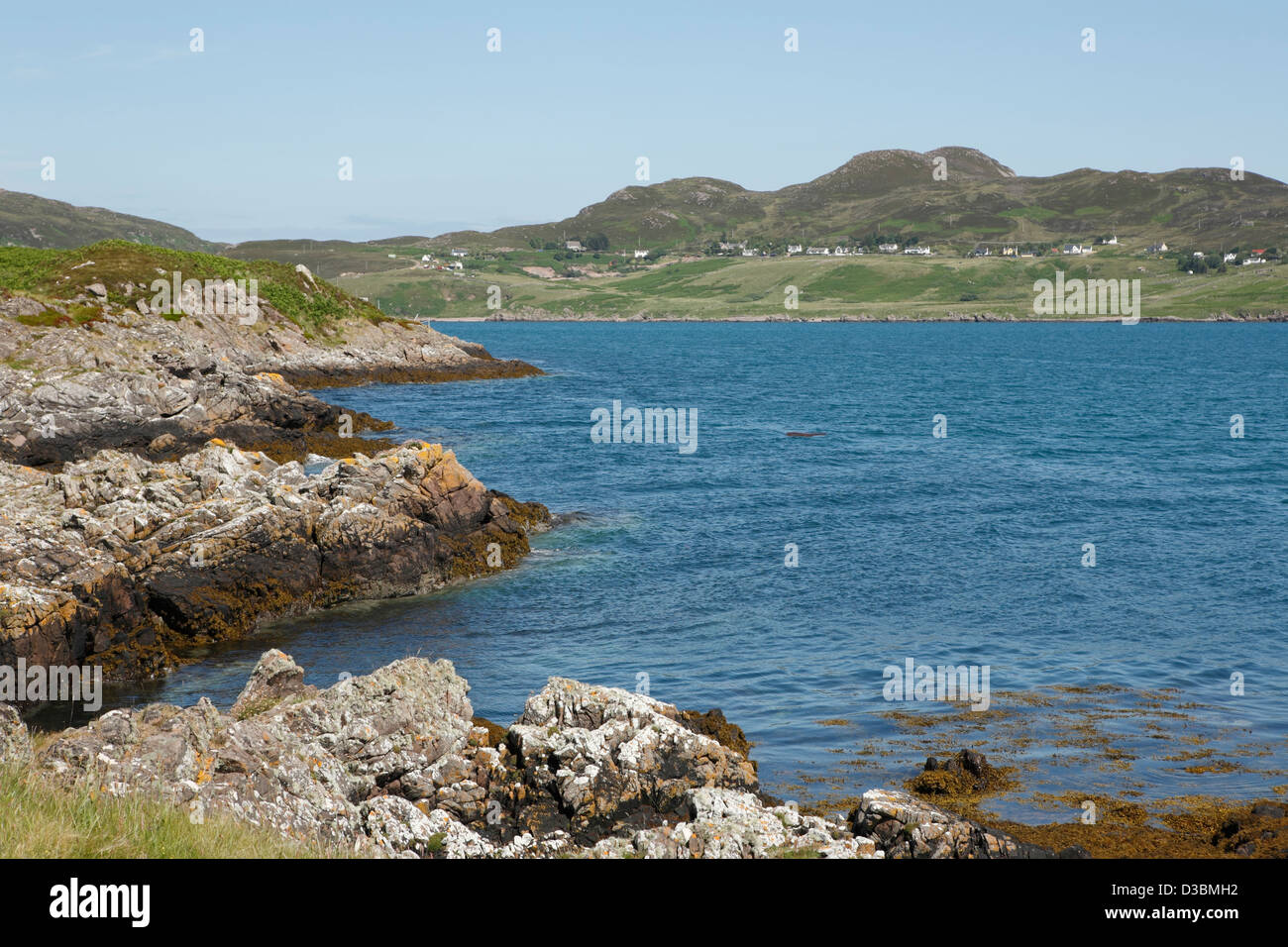 From Tanera Mor a view of the village of Polbain seen on the mainland beyond Stock Photo