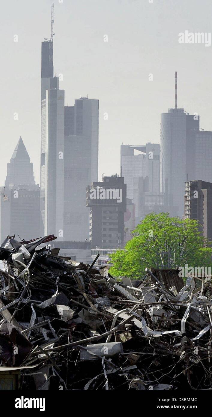 (dpa) - A green tree grows between a junkyard and the skyline of Frankfurt, 14 April 2003. The Commerzbank tower surmounts all other buildings. Stock Photo