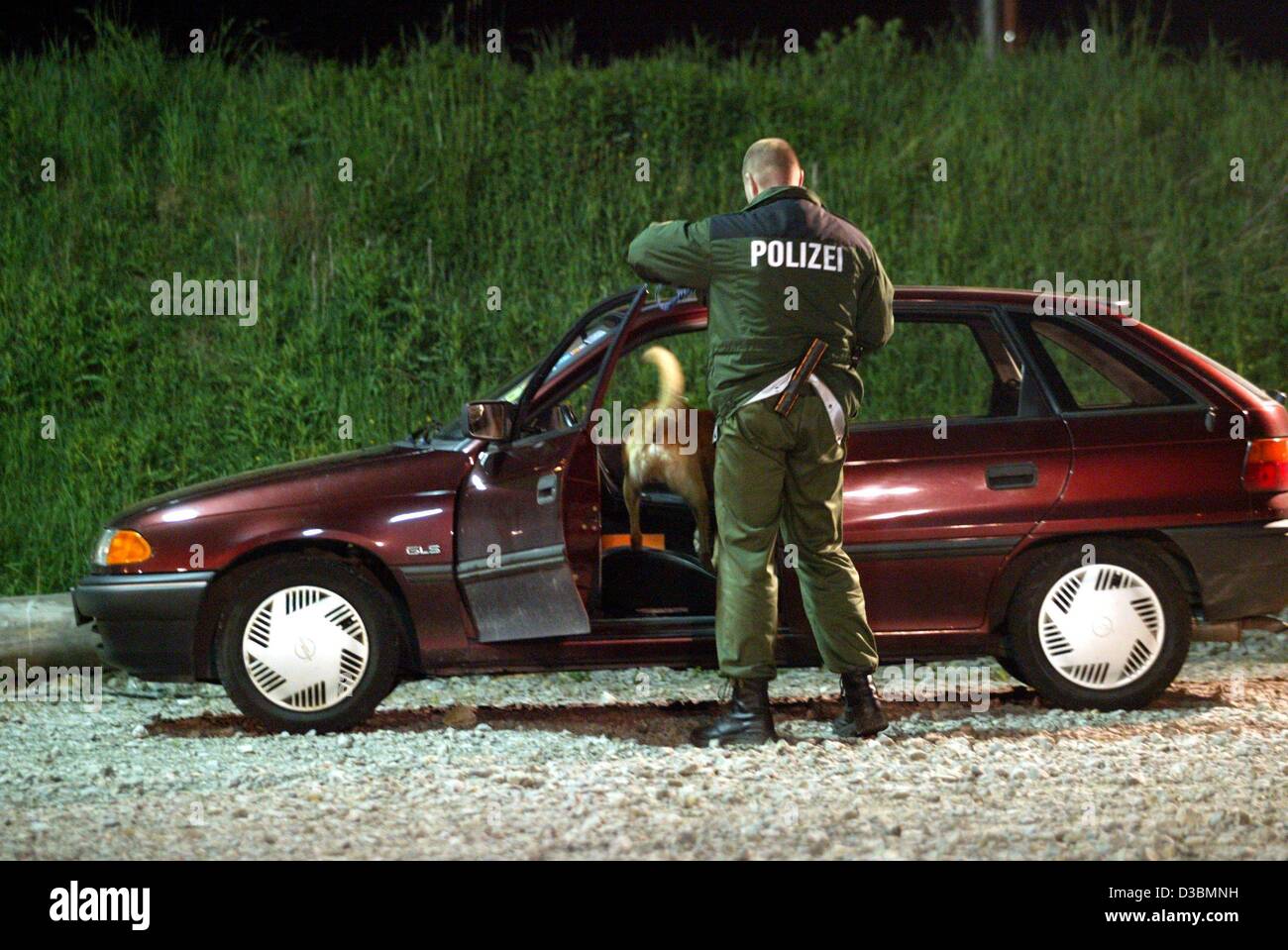 (dpa) - A policeman investigates a car with his drug tracking dog during an alcohol and drug control in Villingen-Schwenningen, Germany, 17 May 2003. Most accidents in Germany are caused by young disco visitors, who ignore the recommendation 'don't drink and drive'. Stock Photo
