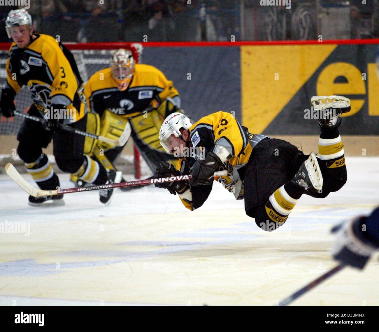 (dpa) - Canadian Gary Shuchuk of the Krefeld Pinguine (Krefeld penguins) seems to fly over the ice rink during the playoff semi final game of the German ice hockey league against the Berlin Eisbaers (Berlin polar bears) in Berlin, 4 April 2003. Krefeld wins 1-0. Stock Photo