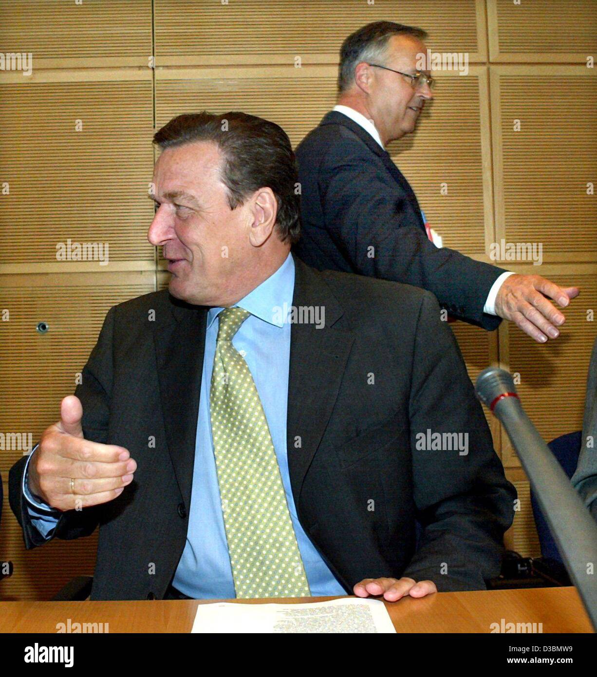 (dpa) - German Finance Minister Hans Eichel in the background walks past German Chancellor Gerhard Schroeder who is laughing during a conversation, ahead of an SPD party meeting in Berlin, 19 May 2003. Stock Photo