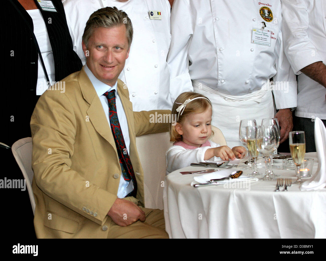 (dpa) - The Belgian royal family - Crownprince Philippe and Princess Elisabeth-  takes a seat in a restaurant on the occasion of the Belgian National Day on Thursday, 21 July 2005, Brussells, Belgium. Stock Photo