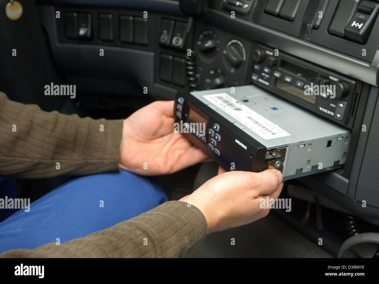 (dpa) - A device for the acquisition of data of the truck toll fees by the company Grundig is being built in into the cockpit of a truck in Berlin, 20 May 2003. Starting 1 September 2003, heavy goods vehicle drivers will have to pay a highway toll in Germany. In recent debates the toll has been lowe Stock Photo