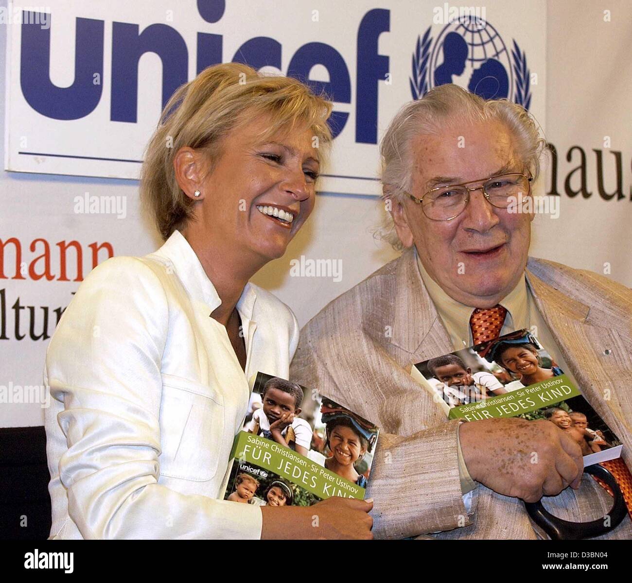 (dpa) - The Unicef ambassadors, German TV host Sabine Christiansen and actor Sir Peter Ustinov, present the book entitled 'Fuer jedes Kind' ('For Every Child') at a presentation held in Berlin, 22 May 2003. They are the editors of the book published for the 50th anniversary of the children's fund or Stock Photo
