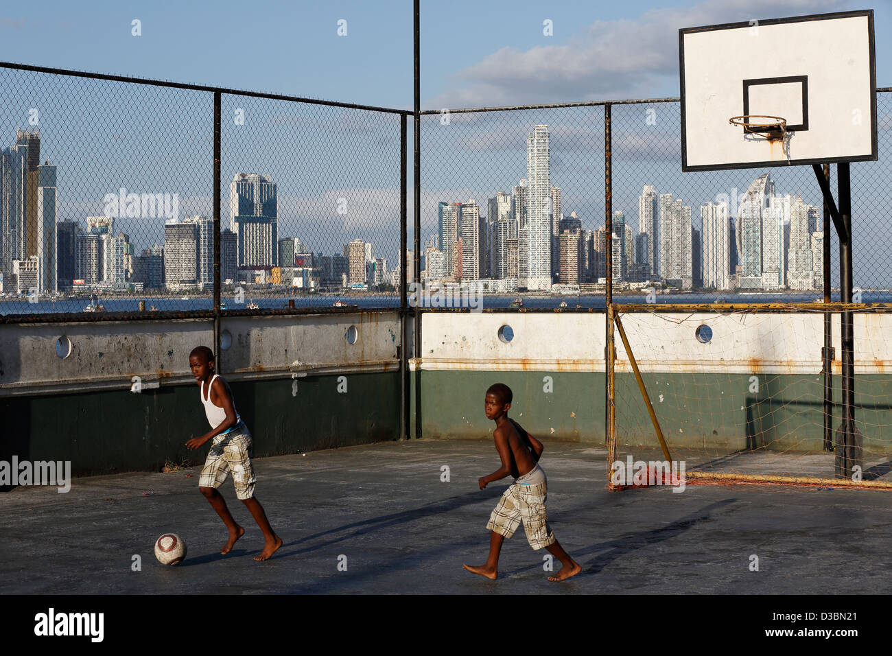 Boys playing soccer on a basketball court, Panama City, Panama Stock