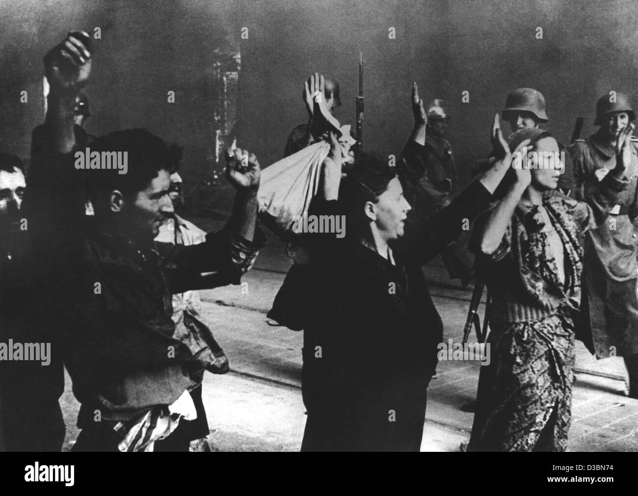 (dpa files) - German soldiers guard a group of Jewish women and men holding their hands up on a street in Warsaw (undated filer). This picture originates from a report by the German military commissioner for the liquidation of the Warsaw Ghetto after the capture of the Polish capital by German troop Stock Photo