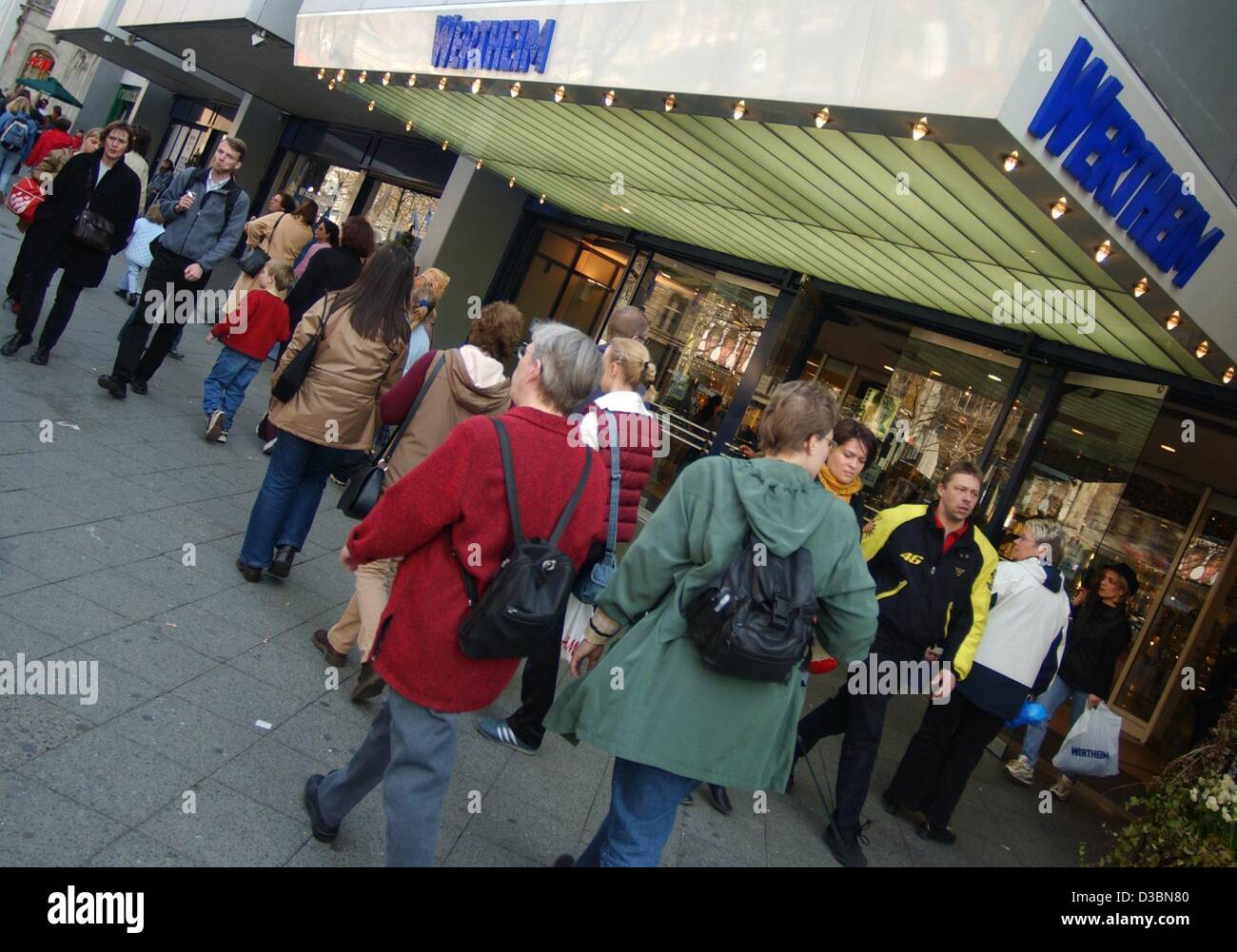 (dpa) - People walk past the Wertheim department store in Berlin, 14 April 2003. The department store, which belongs to the German department store chain KarstadtQuelle, still carries the name of its founder. Presently, a U.S. Federal Court judge is weighing Karstadt-Quelle's request to throw out a  Stock Photo