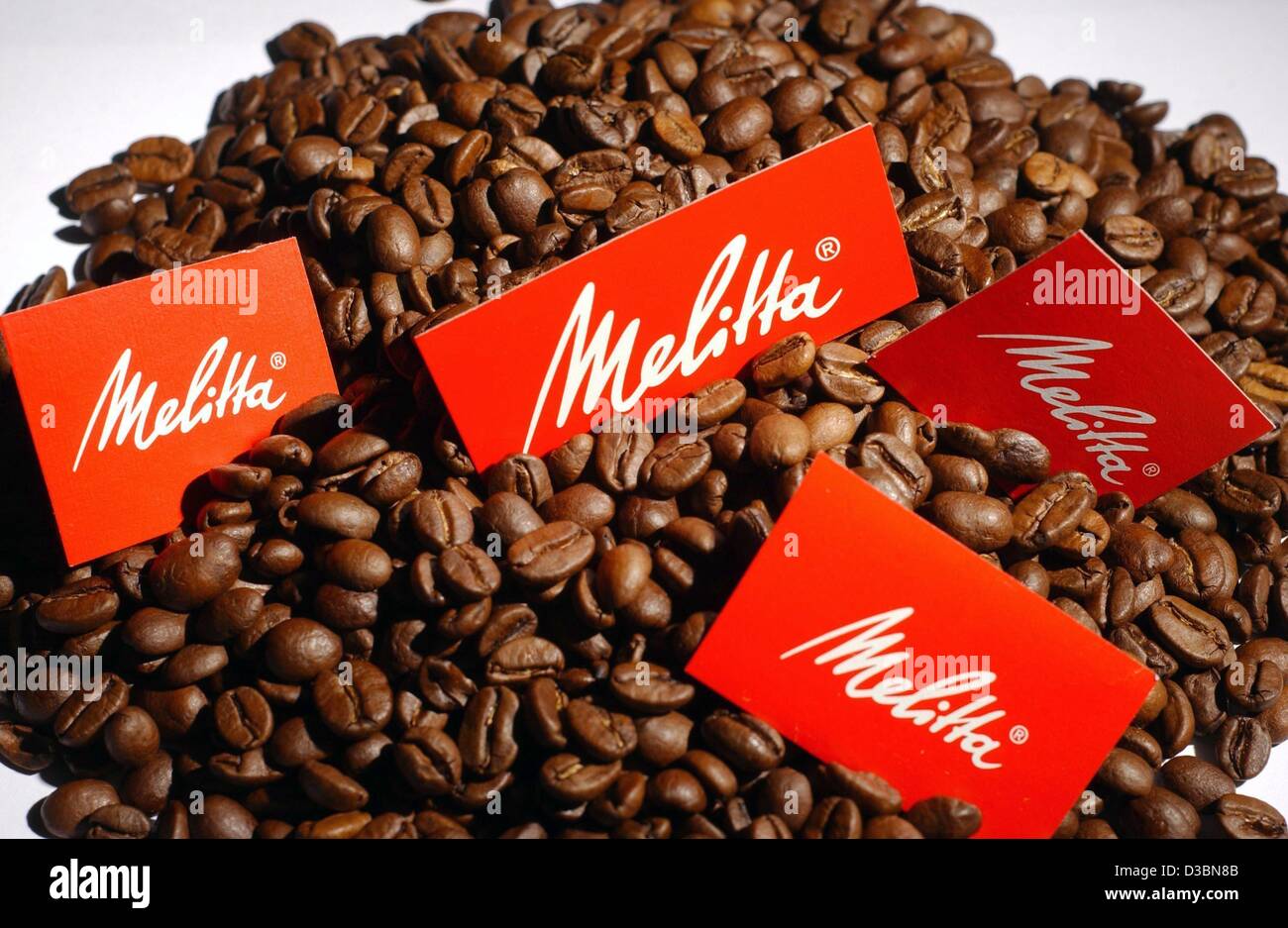 (dpa) Red signs showing the Melitta logo are placed on coffee beans