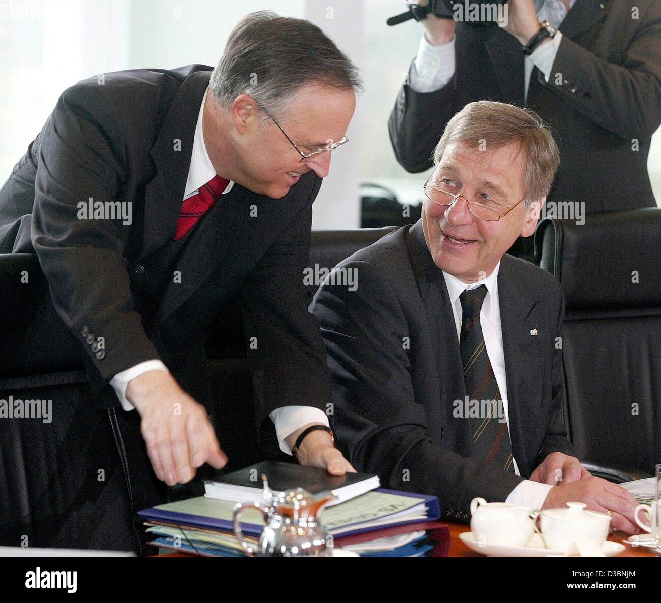 (dpa) - German Finance Minister Hans Eichel (SPD) and German Economy and Labour Minister Wolfgang Clement (SPD) chat with each other just before a cabinet meeting in Berlin, 2 April 2003. The government decided to pass a bill which relieves financially weak local authorities from their financial bur Stock Photo