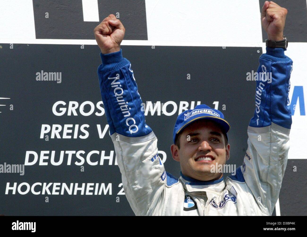 (dpa) - Colombian Juan Pablo Montoya of BMW-Williams cheers on the podium after winning the Formula One Grand Prix of Germany at the Hockenheim race track in Hockenheim, Germany, 3 August 2003. With 65 points Montoya ranks now on 2nd place in the overall standings. Stock Photo