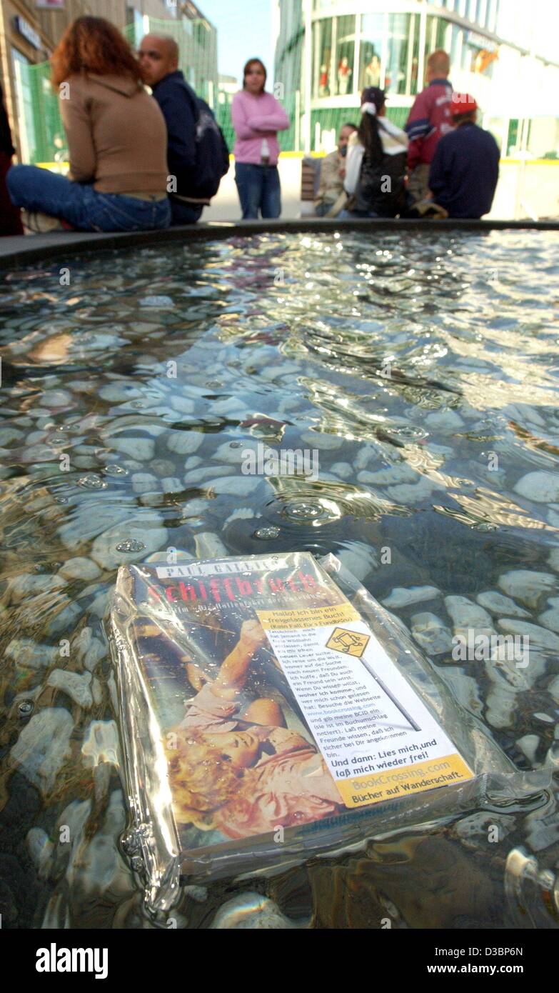 (dpa) - A book rapped in a freezing bag floats in the water of a water fountain in Erfurt, Germany, 14 May 2003. The title of the book reads 'Schiffbruch' (shipwrecked) by Paul Gallico . The idea of 'book crossing' originated in the US where Ron Hornbaker set up a homepage bookworms in 2001. Book en Stock Photo