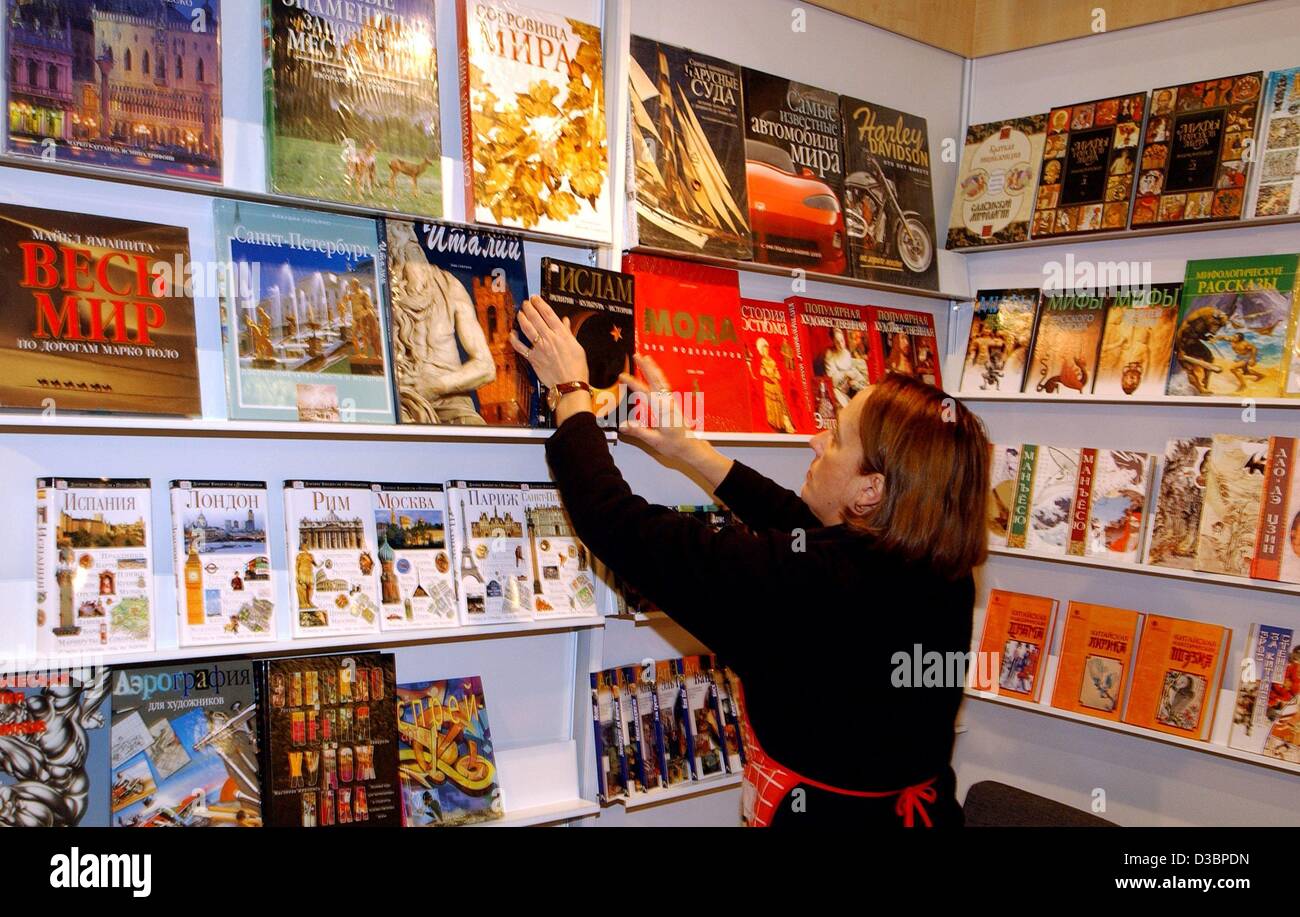 (dpa) - An employee of the Russian AST publisher puts the books on the shelves at the company's market stand at the Book Fair in Frankfurt, 7 October 2003. The world's biggest book fair will run from 7 through 13 October with 6,413 exhibitors from 104 countries. Stock Photo