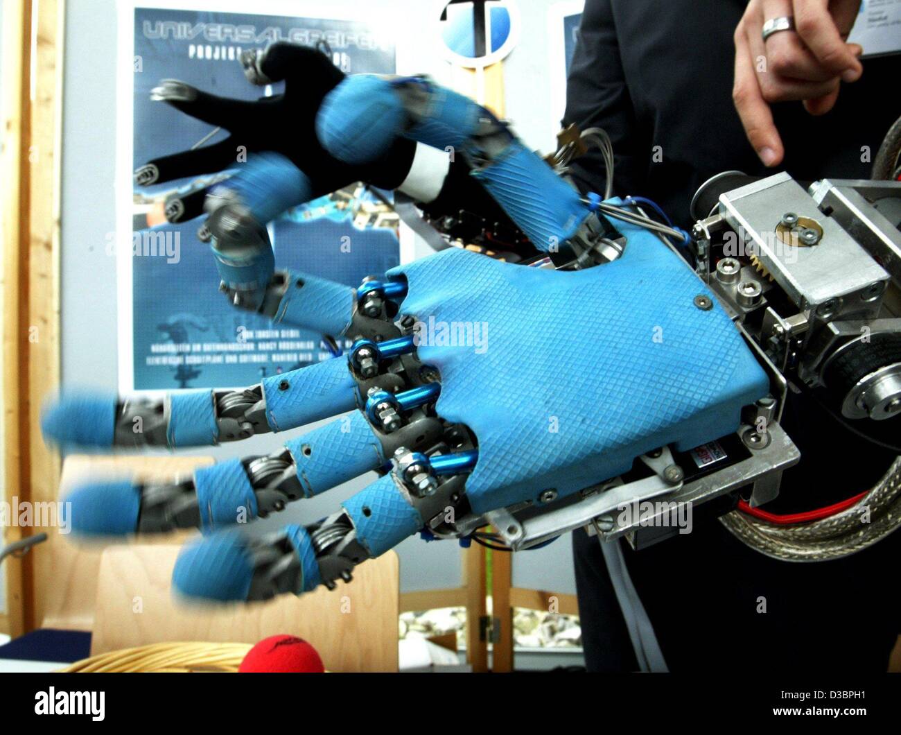 (dpa) - A gripper in the shape of a human hand is presented at the Humanoids 2003 conference in Karlsruhe, Germany, 1 October 2003. The gripper is controlled via a synchronized data glove. Stock Photo