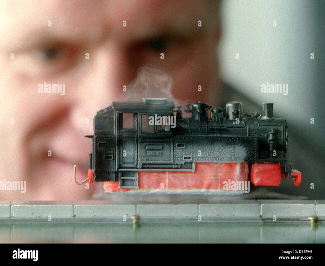 (dpa files) - Professor Ludwig Schultz watches a model locomotive floating over magnetic tracks at the institute for solid body and material research in Dresden, Germany, 29 February 2000. The superconductors at the base of the engine were cooled down to minus 196 degree Celsius with fluid nitrogen  Stock Photo