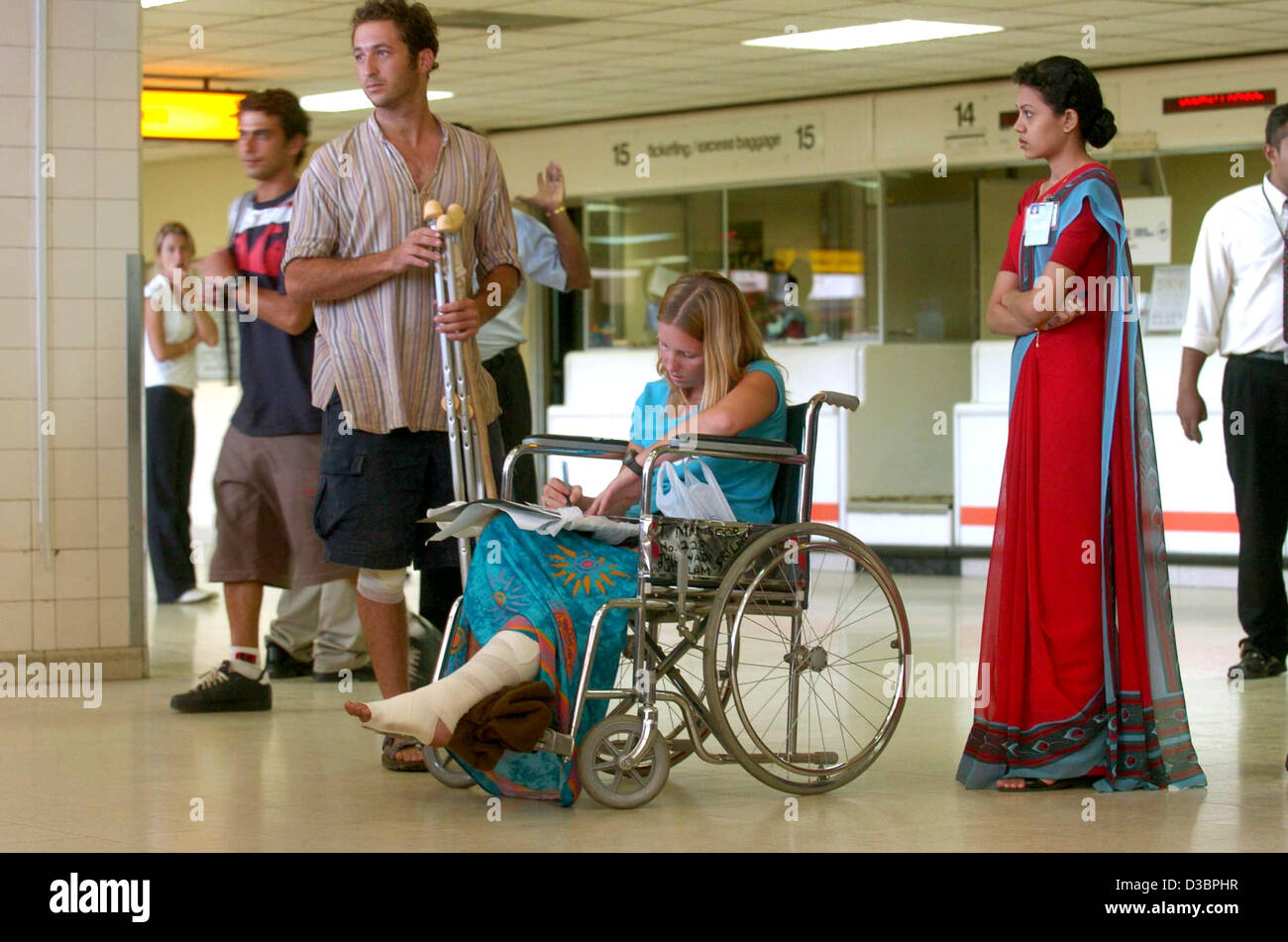 (dpa) - An Israeli female tourist who was hurt during the seaquake on 26 December 2004 fills out forms at the airport in Colombo, Sri Lanka, Thursday 30 December 2004. Most of the foreign tourists have been flown out four days after the devastating tsunami at Sri Lanka's coast. Stock Photo