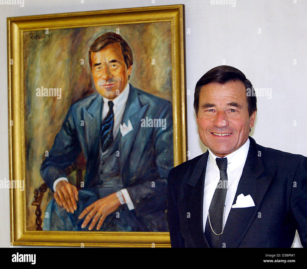 dpa) - Wolfgang Grupp, Executive Director of t-shirt and tennis clothing  producer Trigema, stands next to a painting featuring himself at the  company headquarters in Burladingen, Germany, 16 December 2004. Trigema  which