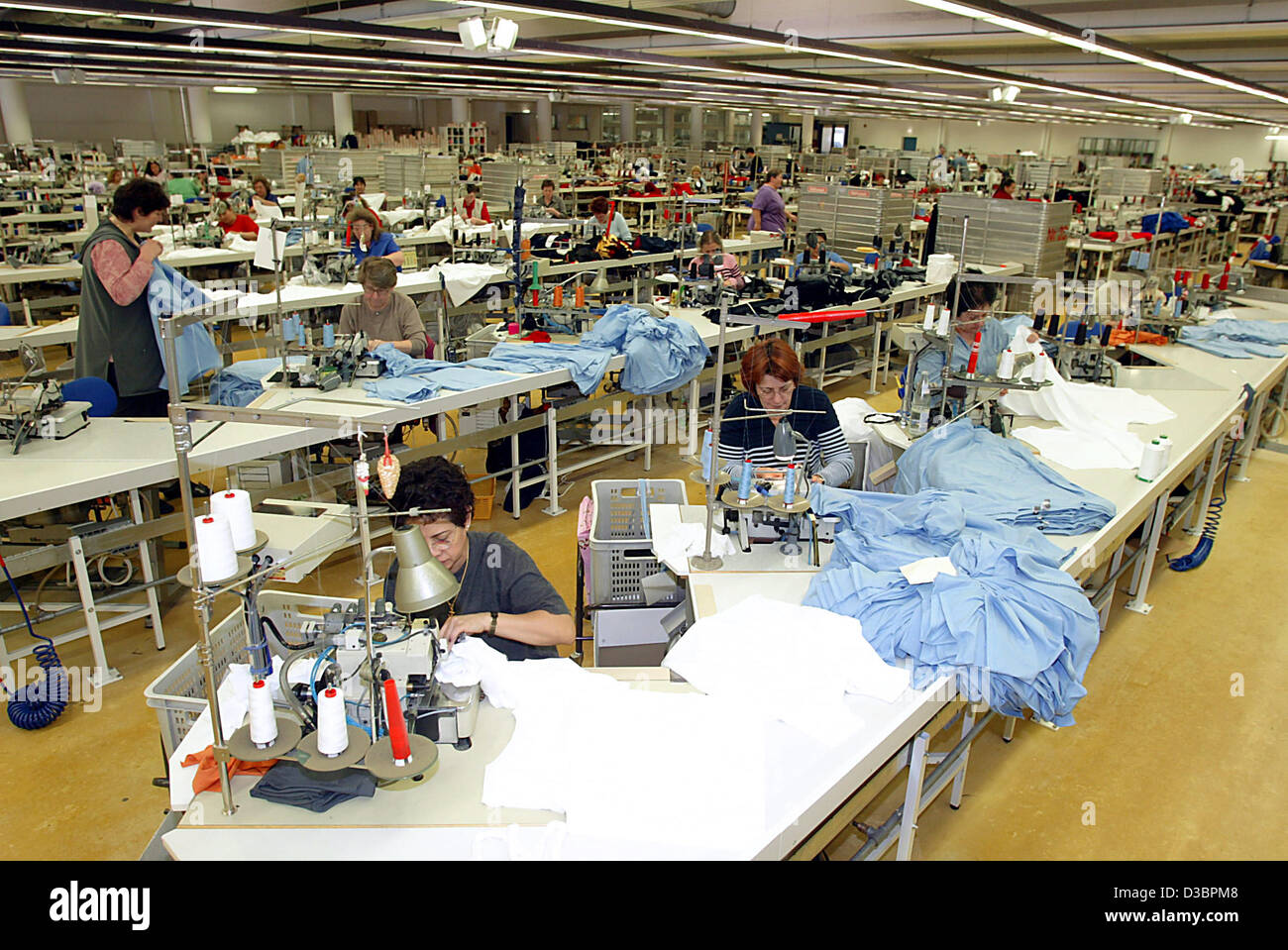 (dpa) - Female employees of t-shirt and tennis clothing producer Trigema fulfill their work in Burladingen, Germany, 16 December 2004. Trigema which has about 1,200 employees has been making profits for the last 35 years. Executive Director Wolfgang Grupp took the company over from his father in 196 Stock Photo