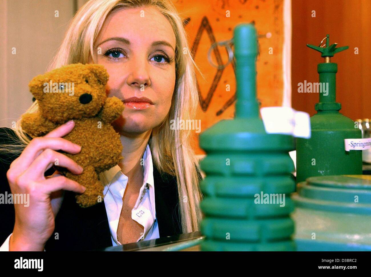 (dpa) - Designer Jette Joop shows symbolically a teddy bear with one leg while sitting next to landmine models, at the city hall in Hamburg, 2 October 2003. Joop, who supports the 'Helft Afrika' (help Africa) campaign of the German Red Cross, appealed for aid for the landmine victims in Africa. Acco Stock Photo