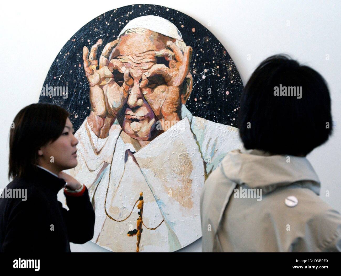 (dpa) - Two visitors examine a painting called 'Ich sehe was, was ihr nicht seht' (i can see what you can't see) resembling the Catholic pope by Cornelia Schleime during the 8th Art Forum, the international trade fair for contemporary art, in the exhibition pavilion in Berlin, 1 October 2003. Around Stock Photo