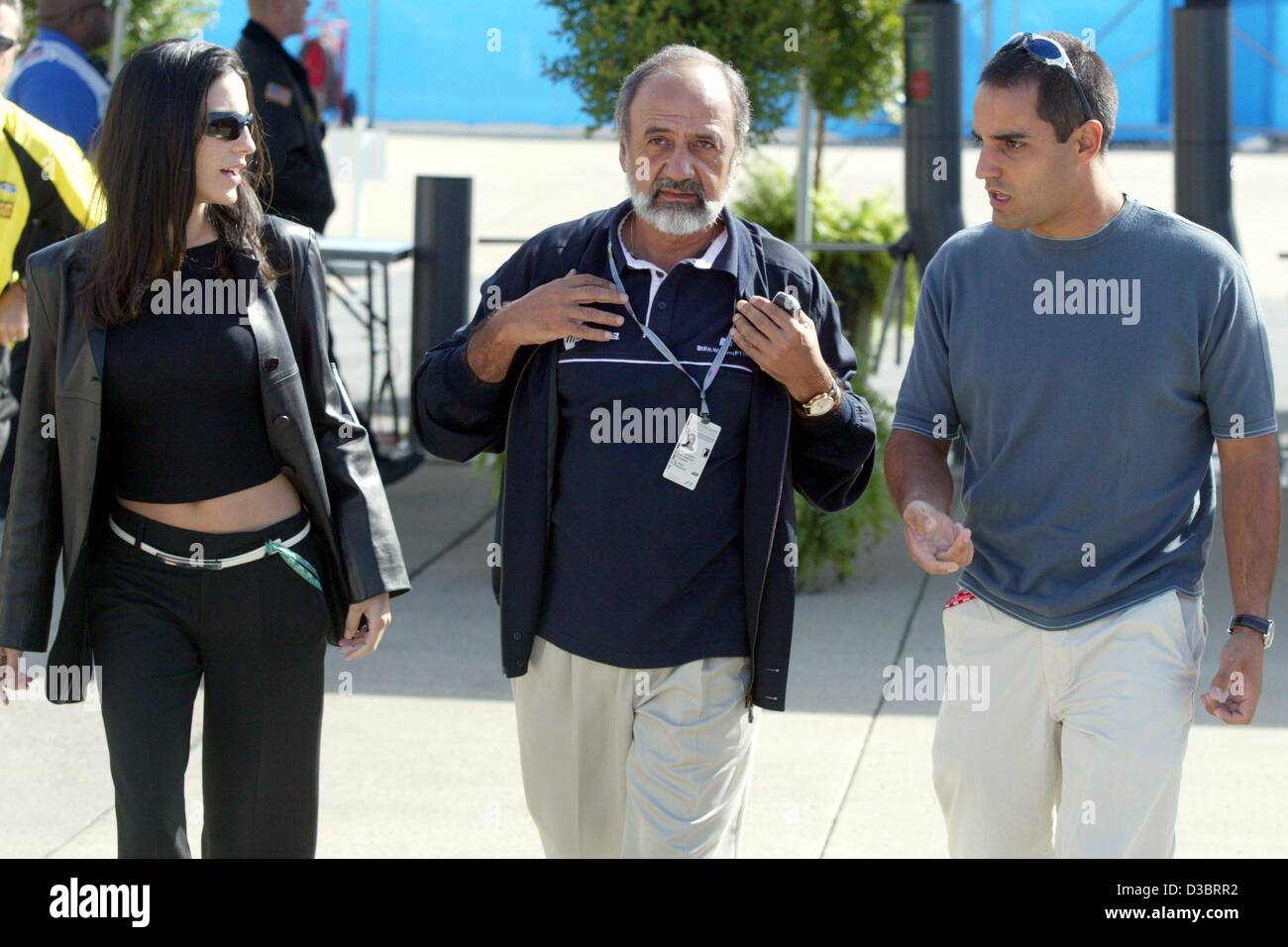 (dpa) - Colombian formula one pilot Juan Pablo Montoya (R) arrives with his wife Connie (L) and his father Pablo at the paddock at the race track in Indianapolis, USA, 25 September 2003. With an open day for the public thousands of fans were attracted to the race track two days ahead of the United S Stock Photo