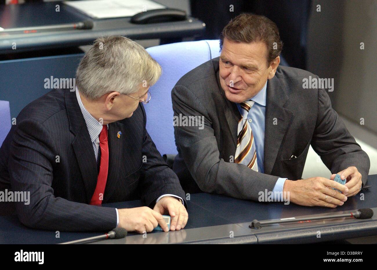 (dpa) - German Chancellor Gerhard Schroeder (R) and Foreign Minister Joschka Fischer hold their ballot cards in their hands ahead of a vote on the healthcare reform in the Bundestag in Berlin, 26 September 2003. The ruling red-green government won the vote for the healtcare reform with a vote of 297 Stock Photo