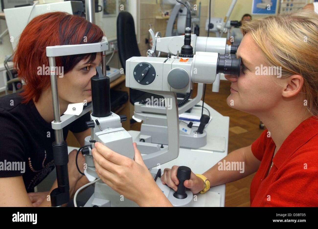 (dpa) - Apprentice Marita Koch (L) examines the eyes of her colleague Steffi Schletzke, at an opticians' school in Jena, Germany, 18 June 2003. The school offers two-year courses for 48 students a year and is the oldest school of its kind in Germany. Stock Photo
