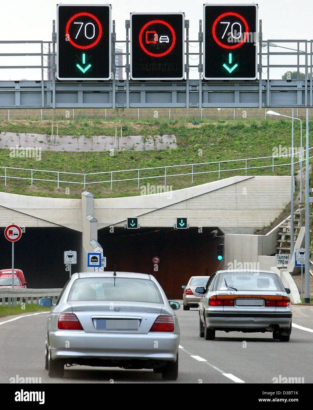 (dpa) - Cars drive into the newly opened tunnel under the River Warnow in Rostock, northern Germany, 12 September 2003. The tunnel was privately financed and is the first traffic project in Germany for which a toll has to be paid. The 790 m long tunnel cost around 220 million euros to build and was  Stock Photo