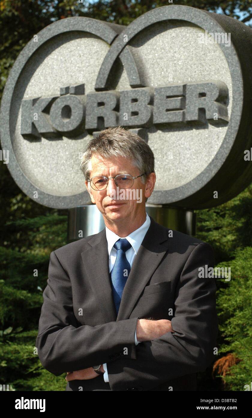 (dpa) - Werner Redeker, CEO of the Koerber corporation, poses in front of the Koerber logo at the company's headquarters in Hamburg, 17 September 2003. Koerber announced that it dips into red ink this year, expecting a decrease of turnover of around 10 per cent. The group plans to slash 1,000 of 8,3 Stock Photo