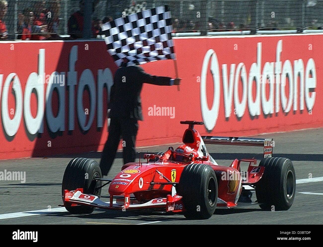 (dpa) - German formula one pilot Michael Schumacher of Ferrari crosses the finish line and wins the Grand Prix of Italy in Monza, 14 September 2003. Schumacher now leads in the overall standings with 82 points. Stock Photo