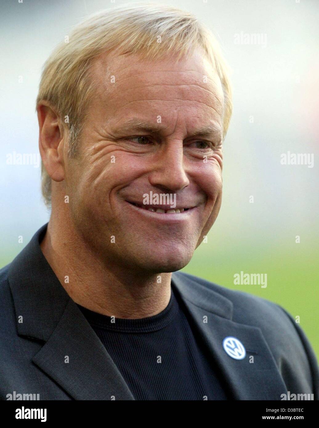 (dpa) - Juergen Roeber, the coach of the German soccer club VfL Wolfsburg smiles after his team defeated Bayern Munich in Wolfsburg, Germany, 13 September 2003. Stock Photo