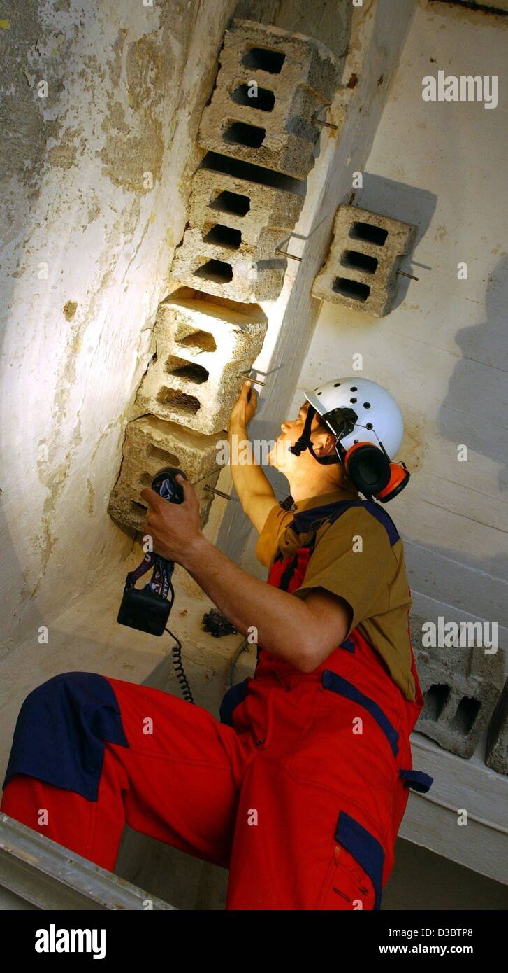 (dpa) - Daniel Triebel of the company Green Way fixes a hollow brick at the ceiling of a bunker near Bernau, Germany, 23 May 2003. The former bunker was transformed in a roost for bats, where they can stay during the winter. Stock Photo