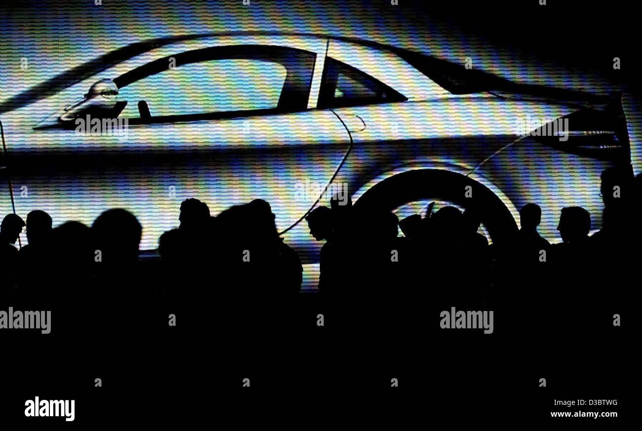 (dpa) - The silhouette of visitors are seen at the 60th IAA international car show in Frankfurt, Germany, 9 September 2003. Stock Photo