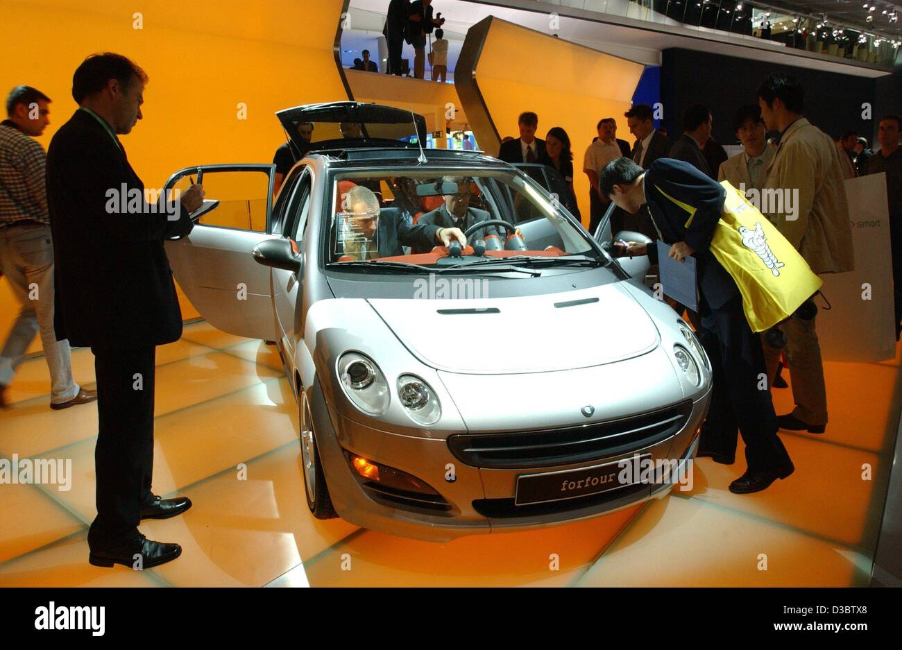 dpa) - Groups of visitors look at the Skoda Roomster at the stand of Skoda  during the IAA international car show in Frankfurt Main, Germany, 9  September 2003. This prototype of a