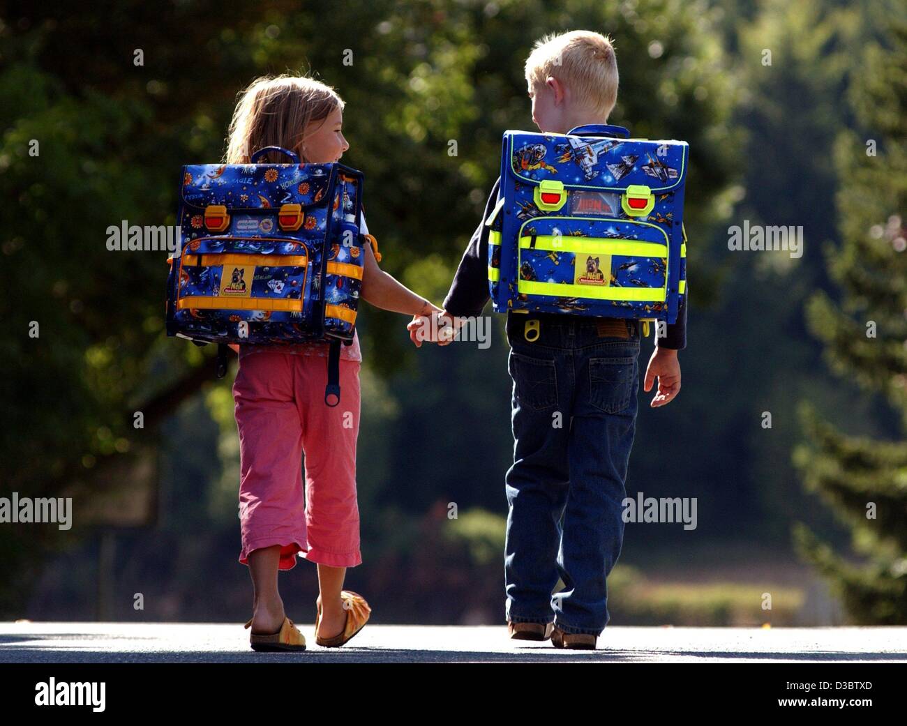 (dpa) - Two first graders go hand in hand to school, in Parsberg ...